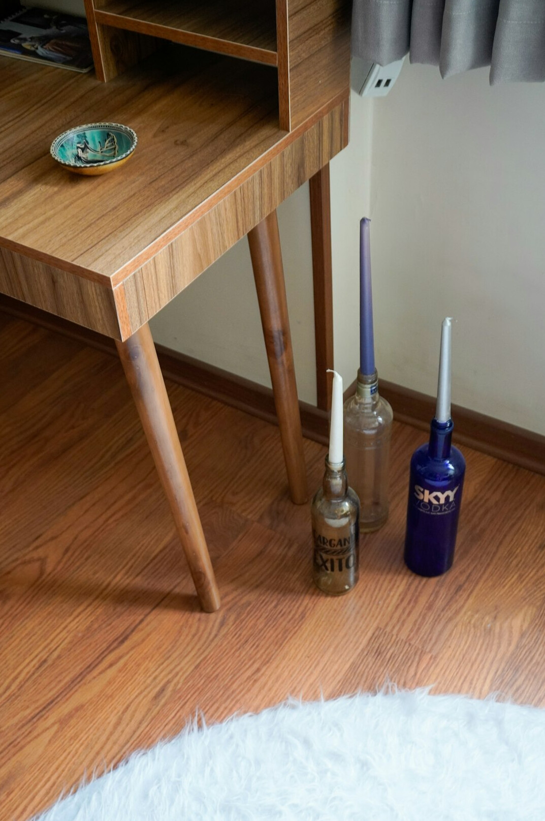 Top-down view of a wooden table with books, notes and a fountain pen